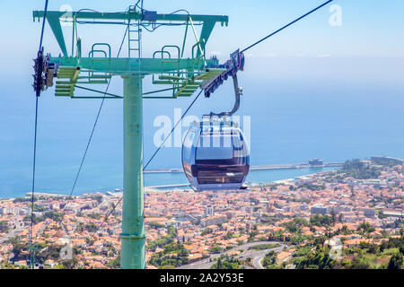Cable car with cabins above city and sea on island Madeira between Funchal and Monte Stock Photo