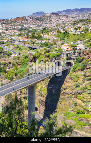 Cars driving on highway and overpass with two  tunnels at Madeira in country Portugal Stock Photo