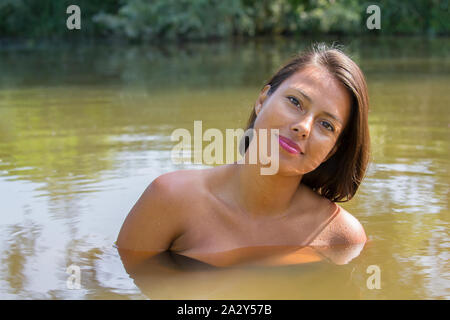 Portrait of beautiful young colombian woman in natural water Stock Photo