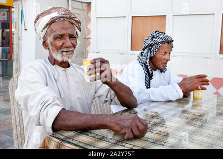 Handsome senior men with hijab drinking coffee and tea Stock Photo