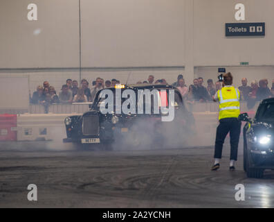 Paul Swift stunt driver, MC'd by Tiff Needell at London Motor Show May 2019, Excel London. Stunt taxi Stock Photo