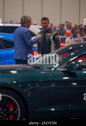 Paul Swift stunt driver, MC'd by Tiff Needell at London Motor Show May 2019, Excel London. Ford Mustang Stock Photo