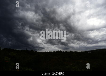 Thundercloud supercell seen from below, gray storm clouds Stock Photo