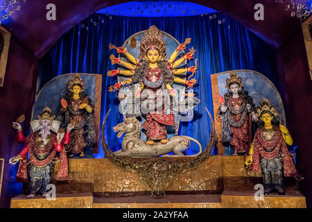 Goddess Durga idol at decorated Durga Puja pandal, shot at colored light, at Kolkata, West Bengal, India. Durga Puja is biggest religious festival of Stock Photo