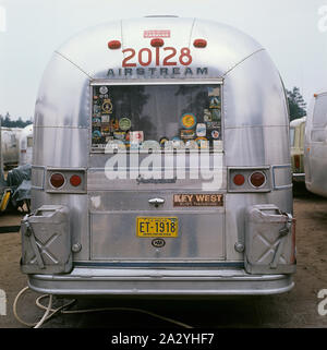 1970s camping. Pictured an American Airstream caravan in aluminium and in the typical 1930s streamline design. The caravan was designed by Hawley Bowlus who was inspirered by the airplane Spirit of St. Louis. Around the world, owners of Airstream caravans meet and this picture was taken in Sweden on September 21 1971. Stock Photo