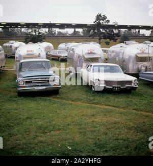 1970s camping. Pictured an American Airstream caravan in aluminium and in the typical 1930s streamline design. The caravan was designed by Hawley Bowlus who was inspirered by the airplane Spirit of St. Louis. Around the world, owners of Airstream caravans meet and this picture was taken in Sweden on September 21 1971. Stock Photo