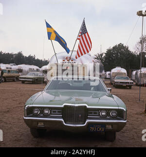 1970s camping. Pictured an American Airstream caravan in aluminium and in the typical 1930s streamline design. The caravan was designed by Hawley Bowlus who was inspirered by the airplane Spirit of St. Louis. Around the world, owners of Airstream caravans meet and this picture was taken in Sweden on September 21 1971. Stock Photo