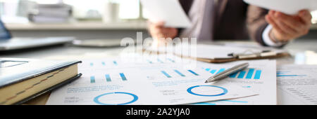 Silver pen lie at important paper on table in office Stock Photo