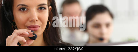 Three call centre service operators at work Stock Photo