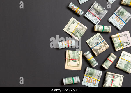 Pile of one hundred US Dollar Bills money on colored background top wiev with copy space for your text in financial concept. Stock Photo