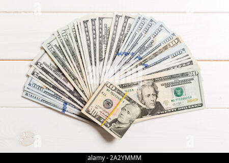 US Dollars: Untidy fan of various US dollar bills Top view of business concept on colored background. Stock Photo