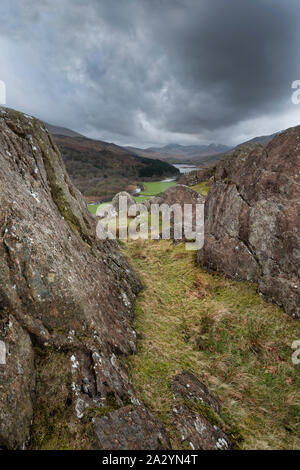 Winter landscape image of the view from Crimpiau and The Pinnacles towards Llynnau Mymbyr and snowcapped Snowdon in the distance Stock Photo