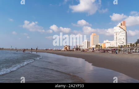 the late afternoon sun lights up the resort hotels on the beach in Tel Aviv in Israel Stock Photo