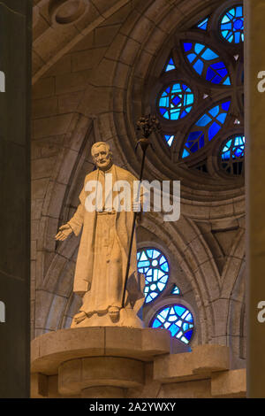 Barcelona, Catalonia, Spain - November 19, 2018: The statue on the background of stained glass windows in the interior of the Temple Expiatori de la S Stock Photo