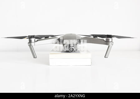 Drone on a book pile in a drone pilot classroom against a white background. No people and empty copy space for Editor's text. Stock Photo