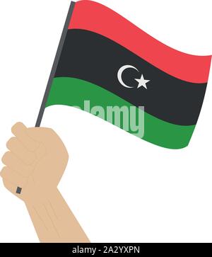 Hand holding and raising the national flag of Libya Stock Vector
