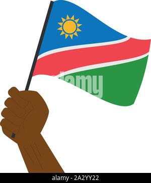 Hand holding and raising the national flag of Namibia Stock Vector