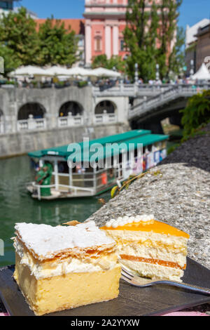Traditional Kremšnita (Bled custard dessert) cakes on plate, Old Town, Ljubljana, Slovenia Stock Photo