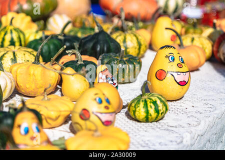 Smiley faces painted on pumpkins on autumn fair Stock Photo