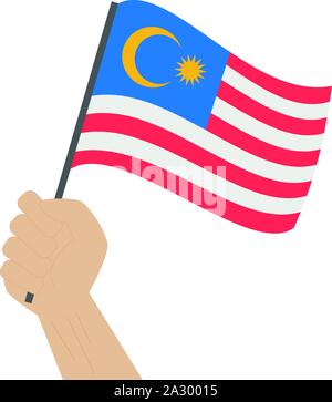 Hand holding and raising the national flag of Malaysia Stock Vector