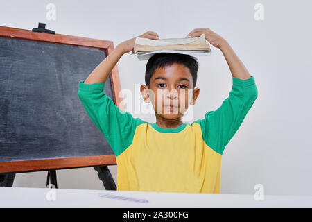 Bored boy too lazy doing his homework, Education concept Stock Photo