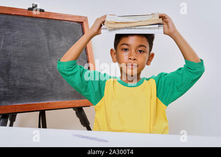 Bored boy too lazy doing his homework, Education concept Stock Photo