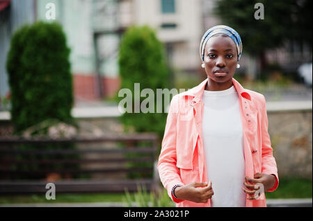 Young modern fashionable, attractive, tall and slim african muslim woman in hijab or turban head scarf posed. Stock Photo