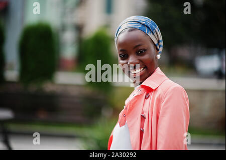 Young modern fashionable, attractive, tall and slim african muslim woman in hijab or turban head scarf posed. Stock Photo