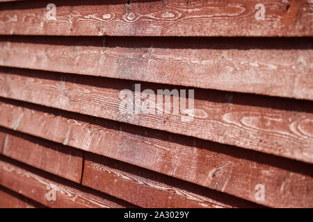 Red wood siding on an old barn building Stock Photo
