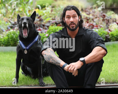 Handler Officer Marshall Mirarchi with US Secret Service dog, Special Operations Canine, Hurricane, as the 10 year old Belgian Malinois receives a PDSA Order of Merit at the County Hall Hotel in London. Stock Photo