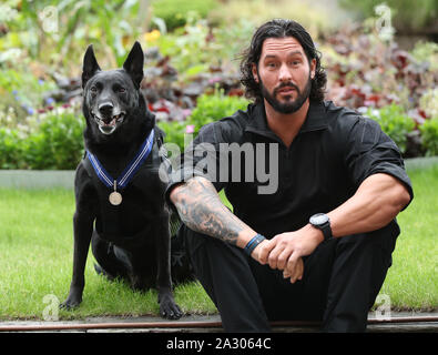 Handler Officer Marshall Mirarchi with US Secret Service dog, Special Operations Canine, Hurricane, as the 10 year old Belgian Malinois receives a PDSA Order of Merit at the County Hall Hotel in London. Stock Photo