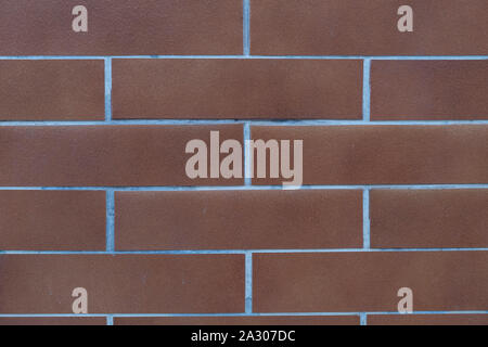 Repeating red brick wall texture typically found in developed areas, often around the back of buildings in cities. The file is a loop ready seamless t Stock Photo