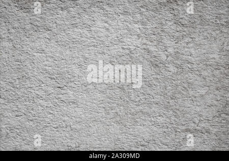 A piece of stone with cracks. Background under concrete, slate, plaster Stock Photo
