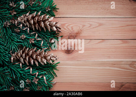 Frame with fir branches, Gingerbread cookies and Christmas decorations on dark stone background Stock Photo