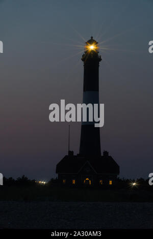 Fire Island lighthouse beacon spectacular hyper star effect from beacon light shining over Robert Moses beach at night time signaling shoreline to oce Stock Photo