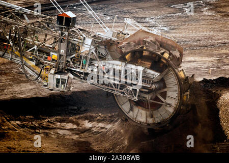 Large bucket wheel excavator mining machine at work in a brown coal open pit mine. Stock Photo