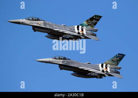 KLEINE-BROGEL, BELGIUM - SEP 14, 2019: Belgian Air Force F-16 fighter jets with D-Day invasion stripes in flight over Kleine-Brogel Airbase. Stock Photo
