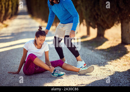 Young woman injury at jogging. running sport injury. Stock Photo