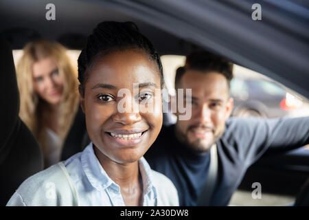 Portrait Of An Afro African Woman Sitting In Car With Her Friends At Background Stock Photo