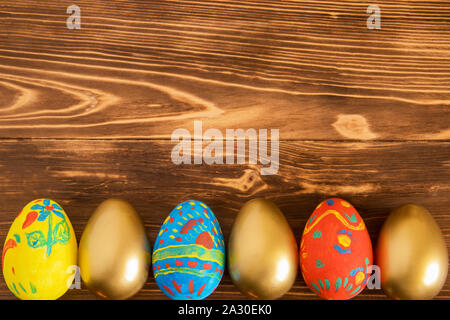 Colored Easter eggs on wooden background with copyspace Stock Photo
