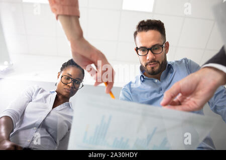 Low Angle View Of Diverse Executive Group Of People Discussing The Business Ideas And Plans Stock Photo