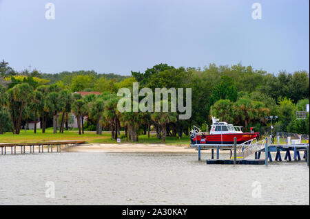 fire boat, boat,palm tree,tree,riverbank,dock,stormy,motion,Jacksonville, Florida, USA - September 19,2019:  Passing views from cruise ship cabin balc Stock Photo