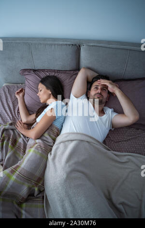 Young man is having trouble with sleep. Stock Photo