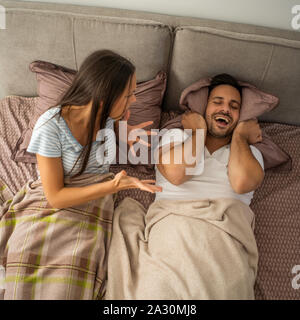 Young couple is arguing in bed. Stock Photo