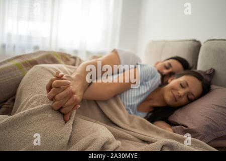 Young couple is resting and sleeping after work. Stock Photo