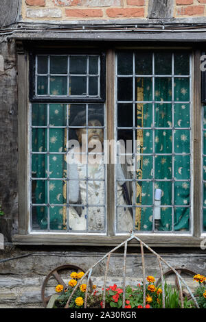Model of Tudor Man Peers Thro' Window of the Shrieve's House, Barn & Museum, Oldest House in Stratford-upon-Avon & Most Haunted Building in England Stock Photo