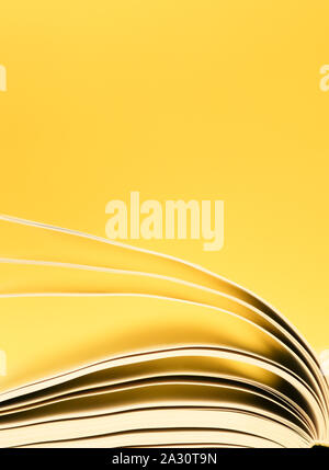 Book pages turning, Pages turning over a yellow background Stock Photo