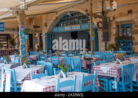 Traditional seating to be found in Greek restaurants around the world, this one in Chania, Crete on the waterfront Stock Photo
