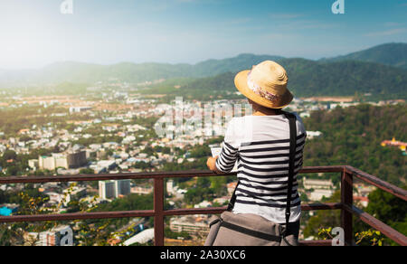 Woman traveler is viewing the map for traveling in phuket town, Travel concept. Stock Photo