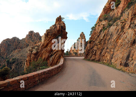 Narrow road called D81 in Corsica France and the red rocks called Calanches Stock Photo